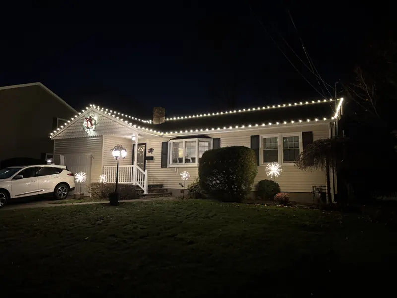 Christmas light installation on Long Island by North Star: warm white roofline on a ranch home