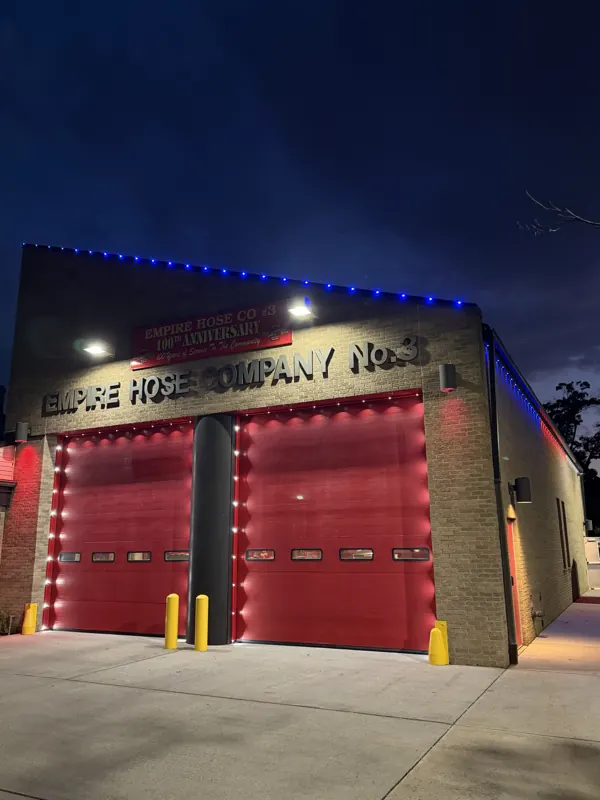 Permanent outdoor lighting on Long Island by North Star: commercial firehouse in red, white and blue