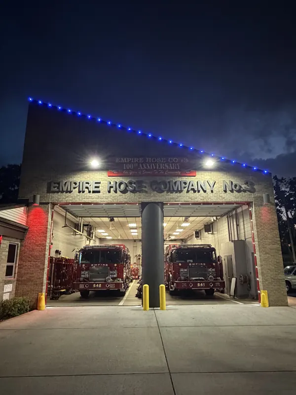 Permanent outdoor lighting on Long Island by North Star: firehouse bays with red, white and blue roofline