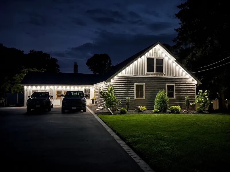 Permanent outdoor lighting on Long Island by North Star: bright white permanent roofline and gable
