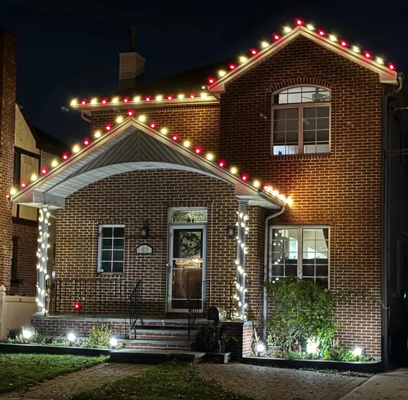 Permanent outdoor lighting on Long Island by North Star: permanent lights set to a red and white holiday pattern